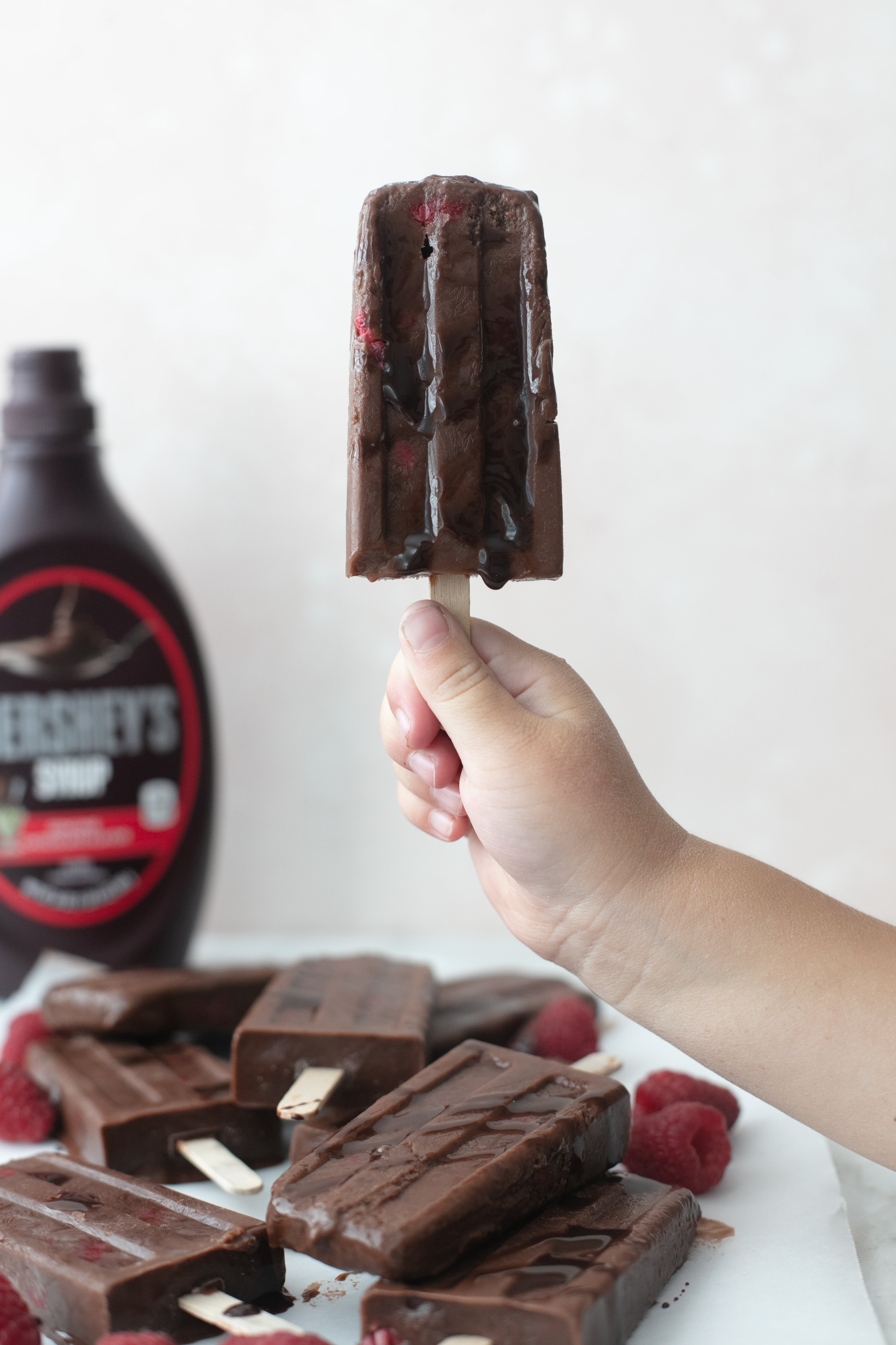 Popsicles made from real milk, Hershey’s Syrup, and raspberries